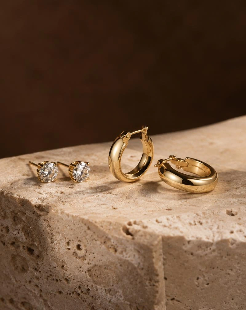 Gold earrings on travertine